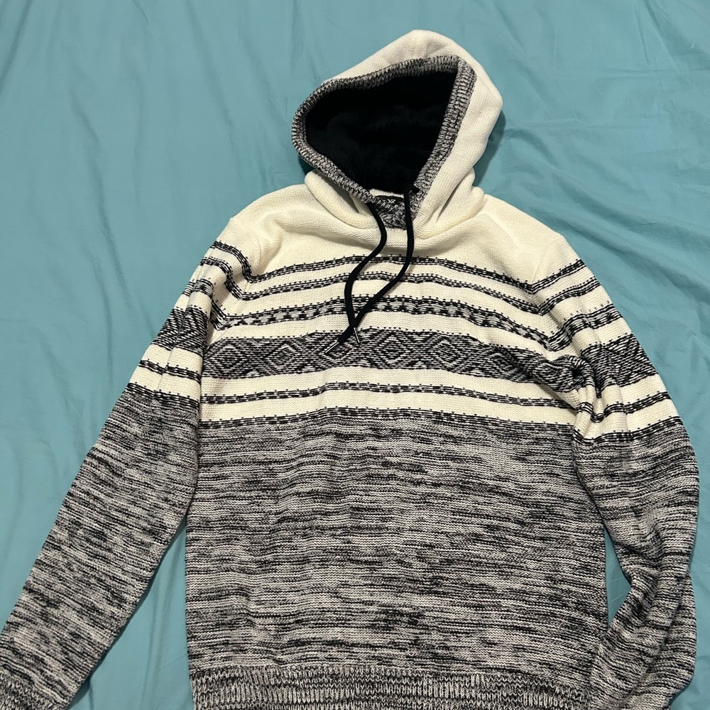 Selling a black and white hoodie with a fur coat inside the hood.